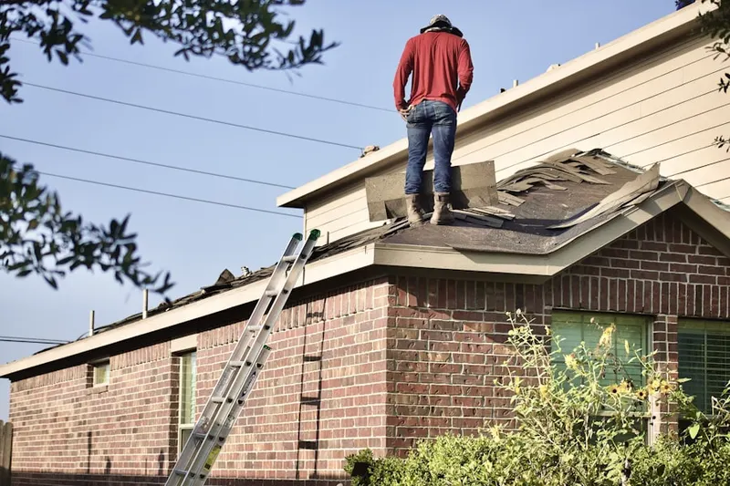 Professional roofer working on a residential roof in Moon Lake Estates